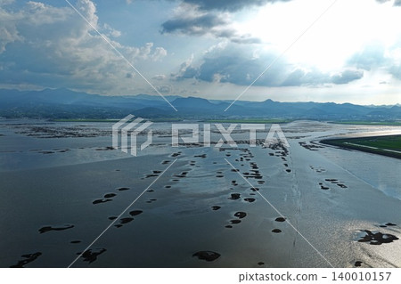An aerial photograph overlooking the tidal flats and reclaimed land of the Ariake Sea in Kishima District, Saga Prefecture. An aerial photograph overlooking the tidal flats and reclaimed land of the Ariake Sea in Kishima District, Saga Prefecture. 140010157