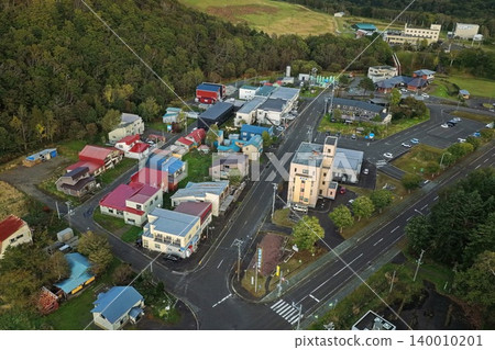 An aerial photograph overlooking the town and forests of Toyotomi Onsen in Hokkaido. 140010201