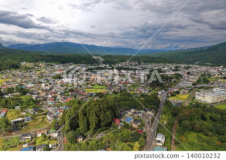 An aerial photograph overlooking the town of Nakanojo, Gunma Prefecture, and its surrounding mountains. 140010232