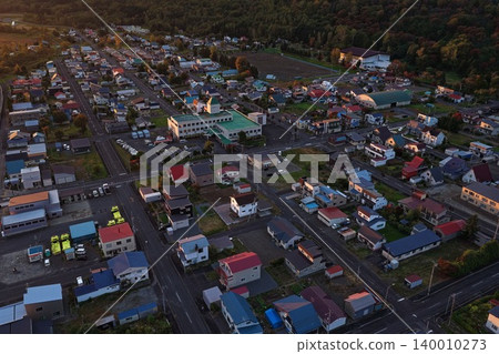 An aerial photograph showing the town of Kamikawa in Hokkaido from a diagonal vantage point. 140010273