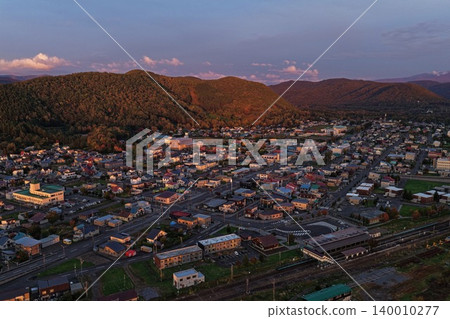 An aerial photograph showing the town of Kamikawa in Hokkaido and the autumn mountains from a diagonal vantage point. An aerial photograph showing the town of Kamikawa in Hokkaido and the autumn mountains from a diagonal vantage point. 140010277