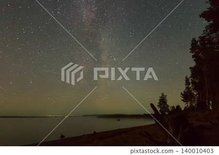 Starry sky background picture of stars in night sky and the Milky Way. Starry sky over the lake. 140010403