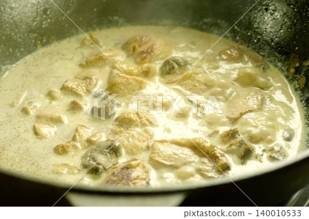 Fried pieces of chicken with mushrooms, in milk in a cup Fried pieces of chicken with mushrooms, in milk in a cup 140010533