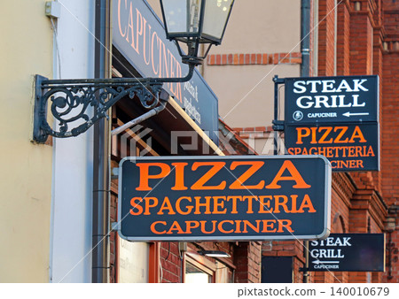 Signs for local restaurants on street 140010679