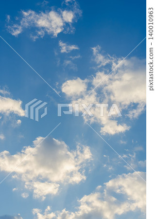 A close-up of clouds shining in the clear blue sky and morning sun on a cold winter morning 05 140010963