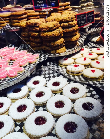 A wide variety of baked goods and cookies adorn the storefront of a Western-style confectionery shop. A wide variety of baked goods and cookies adorn the storefront of a Western-style confectionery shop. 140012278