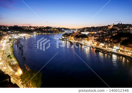 High angle panoramic view of illuminated Douro River and Porto cityscape at night, Portugal High angle panoramic view of illuminated Douro River and Porto cityscape at night, Portugal 140012346