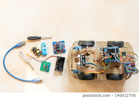 DIY Robot Car Assembly and Components top view. Educational electronics project for STEM learning and robotics 140012756