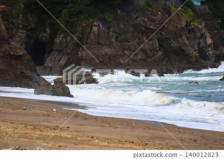 A natural coastal landscape with rocky shores and waves. A natural coastal landscape with rocky shores and waves. 140012823