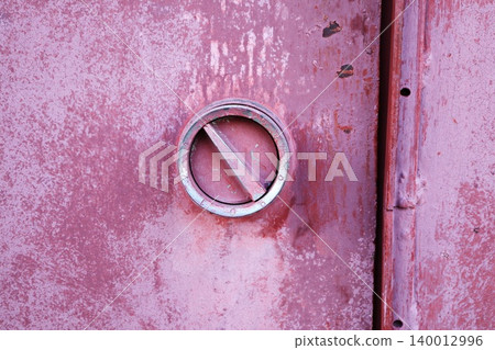 Round Metal Round Handle on Weathered Pink Red Metal Surface, Industrial Hardware Texture Background Round Metal Round Handle on Weathered Pink Red Metal Surface, Industrial Hardware Texture Background 140012996