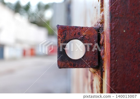 Heavily Rusted Square Metal Bracket with Circular Hole, Weathered Industrial Hardware Detail with Bokeh Background 140013007
