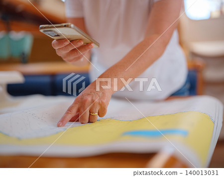 Woman Sailor Studying Navigation Map Inside Yacht Cabin Interior Woman Sailor Studying Navigation Map Inside Yacht Cabin Interior 140013031