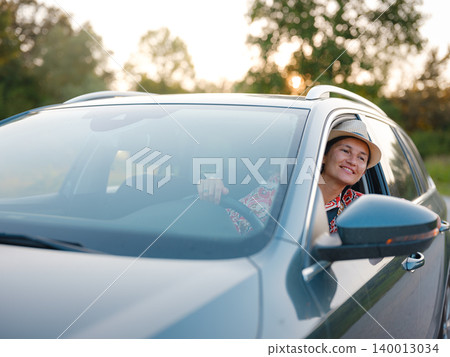 Traveler woman drives car through scenic countryside of Croatia 140013034