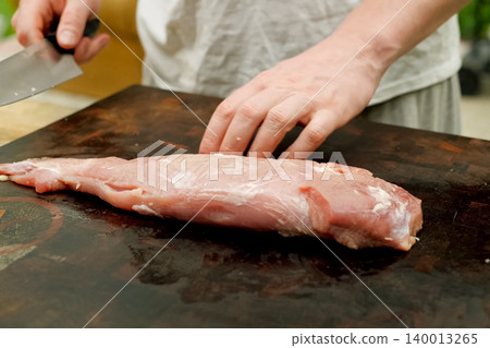 Cutting piece of pork meat on the table. Raw pork. 140013265