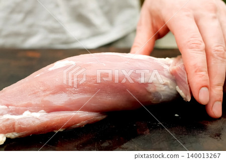 Cutting piece of pork meat on the table. Raw pork. Cutting piece of pork meat on the table. Raw pork. 140013267