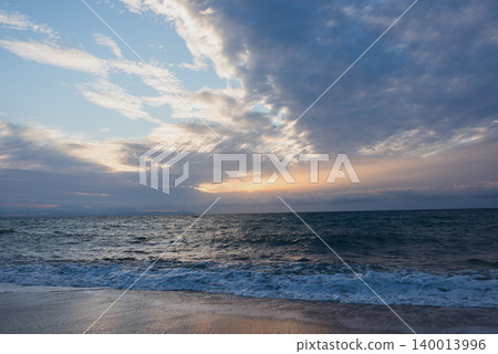 The sky is blue and the sun is setting. The sky is blue and the sun is setting. 140013996