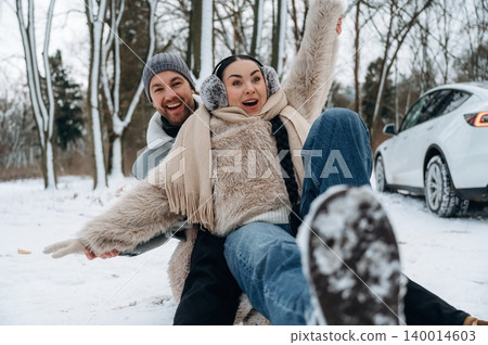 Happy couple enjoying winter fun in snowy landscape, laughing and playing together, showcasing joy and connection in a beautiful outdoor setting Happy couple enjoying winter fun in snowy landscape, laughing and playing together, showcasing joy and connection in a beautiful outdoor setting 140014603