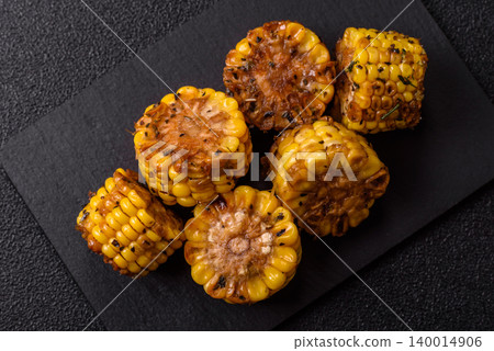 Corn chunks grilled or barbecued with salt and spices. Grilled corn Corn chunks grilled or barbecued with salt and spices. Grilled corn 140014906