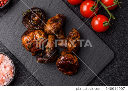 Grilled or barbecued mushroom halves with salt and spices. Grilled mushrooms 140014907