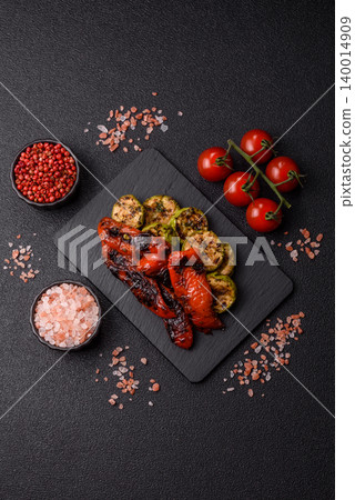 Grilled or barbecued sweet peppers and zucchini slices with salt. Grilled peppers and zucchini 140014909