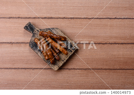 Thin chicken or pork sausages grilled or barbecued. Grilled sausages 140014973