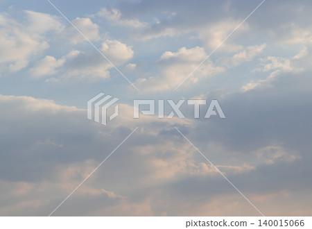 The sky unfolds in a painterly gradient, where fading azure meets a gentle amber horizon. Luminescent clouds, feathered in pearl and peach, drift across this ethereal canvas as deeper shadows of The sky unfolds in a painterly gradient, where fading azure meets a gentle amber horizon. Luminescent clouds, feathered in pearl and peach, drift across this ethereal canvas as deeper shadows of 140015066