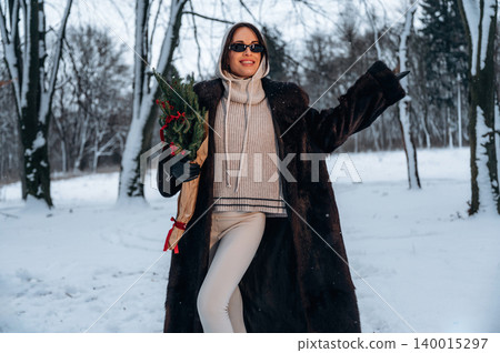 Stylish woman in a luxurious fur coat, holding a bouquet of flowers, poses joyfully in a snowy winter landscape, showcasing winter fashion and holiday spirit Stylish woman in a luxurious fur coat, holding a bouquet of flowers, poses joyfully in a snowy winter landscape, showcasing winter fashion and holiday spirit 140015297