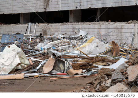 Urban Demolition Debris Pile Outside Abandoned Building Showing Rubble, Metal Pipes and Construction Waste Urban Demolition Debris Pile Outside Abandoned Building Showing Rubble, Metal Pipes and Construction Waste 140015570