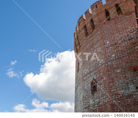 Low angle view of an ancient tower at Smolensk fortress under a cloudy sky. Low angle view of an ancient tower at Smolensk fortress under a cloudy sky. 140016148