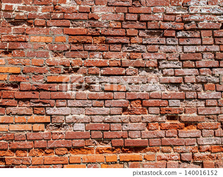Texture of an ancient wall made of very old weathered red bricks. Texture of an ancient wall made of very old weathered red bricks. 140016152