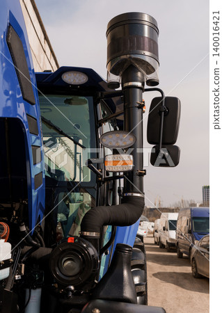 Close Up of Blue Agricultural Tractor Engine and Air Intake Filter Detail in Daylight Close Up of Blue Agricultural Tractor Engine and Air Intake Filter Detail in Daylight 140016421