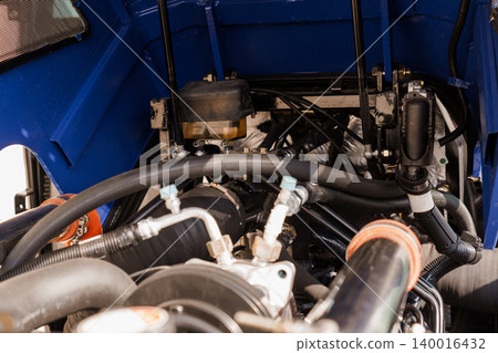 Close up of heavy duty vehicle engine compartment with blue chassis and mechanical components Close up of heavy duty vehicle engine compartment with blue chassis and mechanical components 140016432