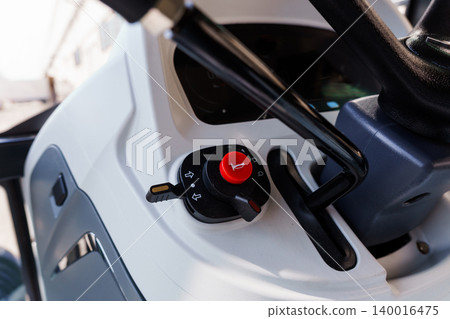 Close up of vehicle ignition switch and key in dashboard of modern white utility vehicle Close up of vehicle ignition switch and key in dashboard of modern white utility vehicle 140016475