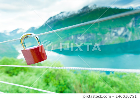 Red padlock and Geirangerfjord from Flydasjuvet viewpoint Norway Red padlock and Geirangerfjord from Flydasjuvet viewpoint Norway 140016751