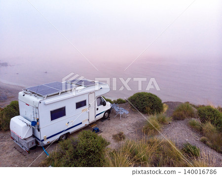 Caravan with solar panels on roof on coast, Spain. Aerial view. Caravan with solar panels on roof on coast, Spain. Aerial view. 140016786