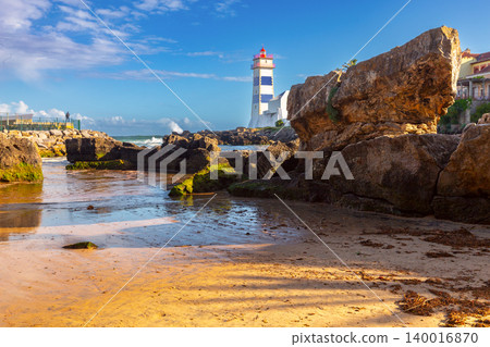Santa Marta lighthouse and rocky Atlantic shoreline in Cascais Portugal Santa Marta lighthouse and rocky Atlantic shoreline in Cascais Portugal 140016870