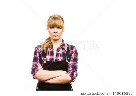 Angry woman wearing dungarees and check shirt Angry woman wearing dungarees and check shirt 140016892