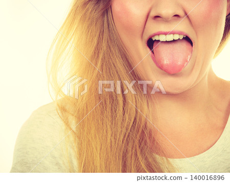 Funny blonde woman sitcking tongue out Funny blonde woman sitcking tongue out 140016896