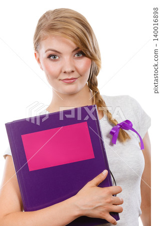 Young teenage student with braid holding books Young teenage student with braid holding books 140016898