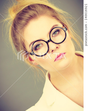 Bored focused college woman teacher wearing eyeglasses Bored focused college woman teacher wearing eyeglasses 140016921
