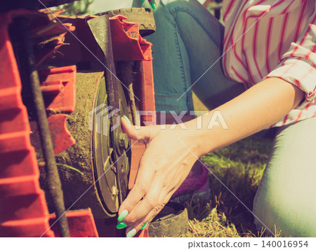 Person having problem with land mower Person having problem with land mower 140016954