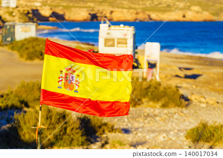 Spanish flag and motorhome camping by the beach with a view of the sea coast 140017034