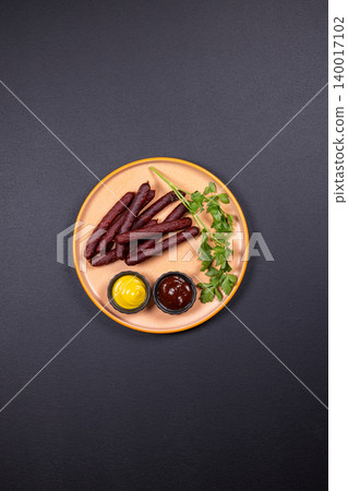 Smoked sausages served with mustard, bbq sauce, and parsley Smoked sausages served with mustard, bbq sauce, and parsley 140017102