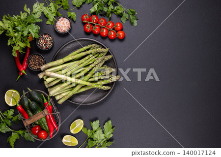 Fresh asparagus and vegetables with spices cooking ingredients Fresh asparagus and vegetables with spices cooking ingredients 140017124
