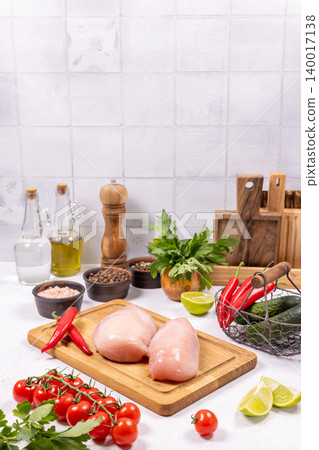 Raw chicken breasts preparing with fresh vegetables and ingredients Raw chicken breasts preparing with fresh vegetables and ingredients 140017138