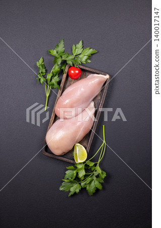 Raw chicken breast fillets with fresh herbs and lime Raw chicken breast fillets with fresh herbs and lime 140017147