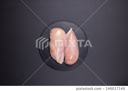 Fresh raw chicken breast fillets on slate plate 140017148