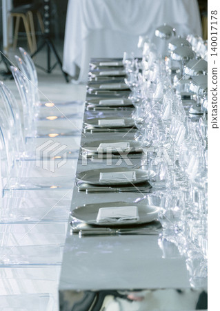 Banquet table with elegant place settings and crystal glasses Banquet table with elegant place settings and crystal glasses 140017178