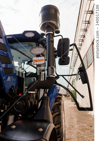Close Up of Blue Agricultural Tractor Engine with Air Intake and Exhaust System Outdoors Close Up of Blue Agricultural Tractor Engine with Air Intake and Exhaust System Outdoors 140017186