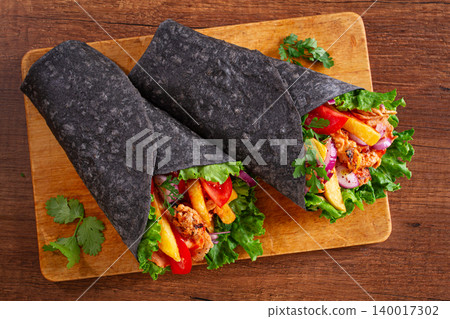 shawarma in black lavash, on a wooden background, chicken shawarma, no people, 140017302